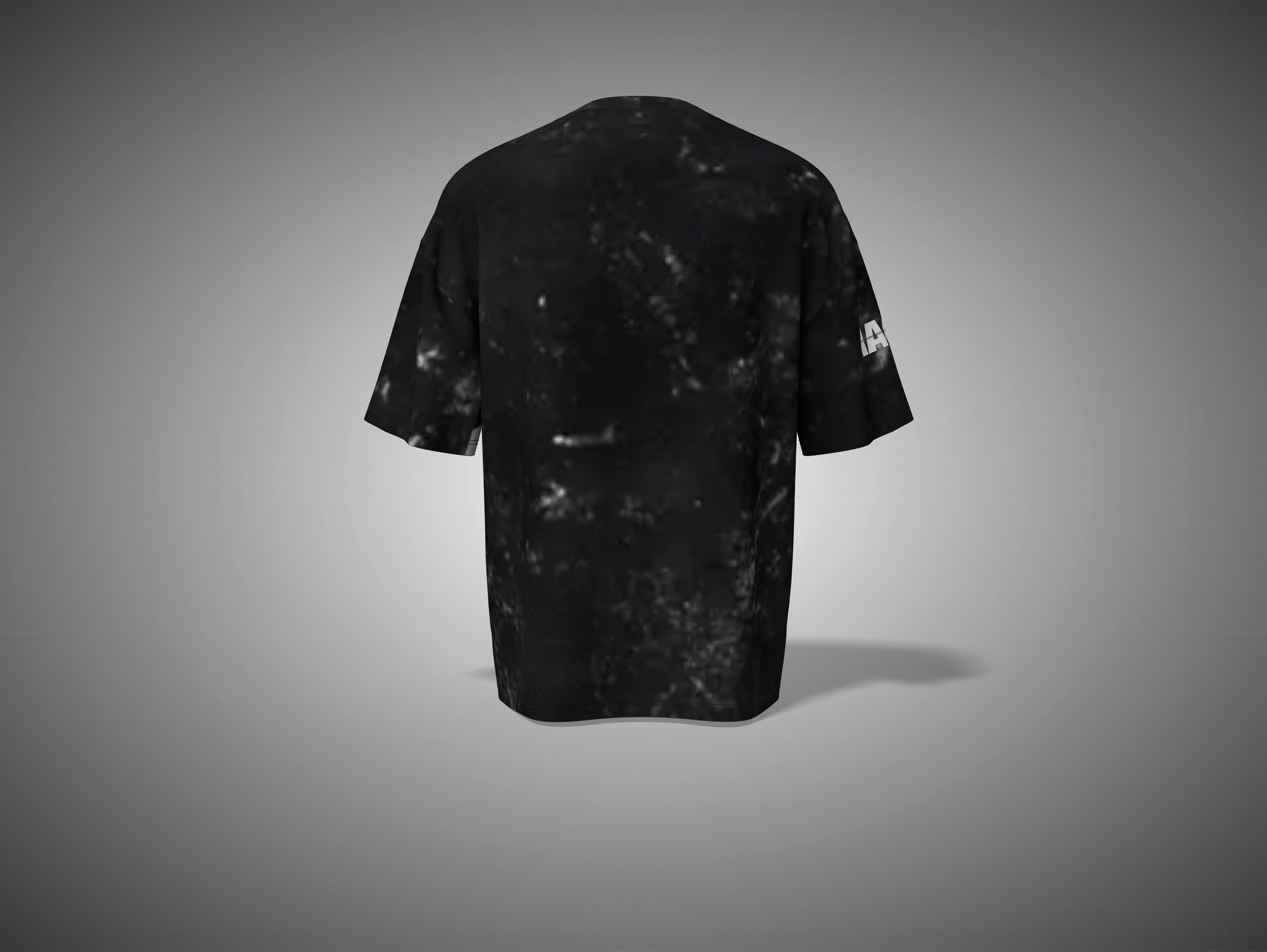 Black t-shirt with a small white logo on the sleeve against a gray background