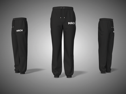 Black pants with 'MACH' branding on a gray background