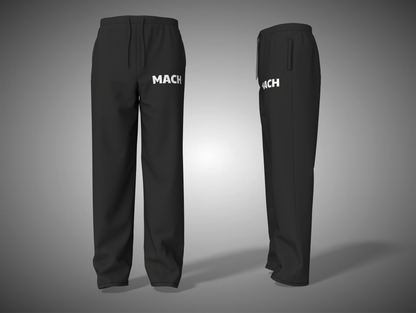 Black pants with 'MACH' branding on a gray background
