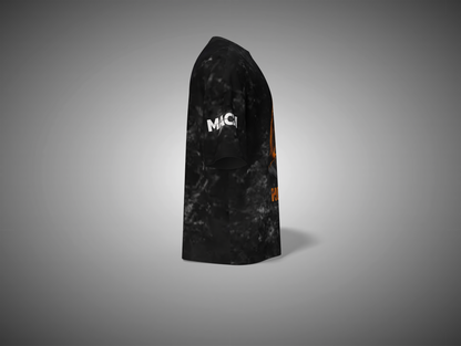 Black and orange patterned t shirt with 'MAC' branding on a gray background