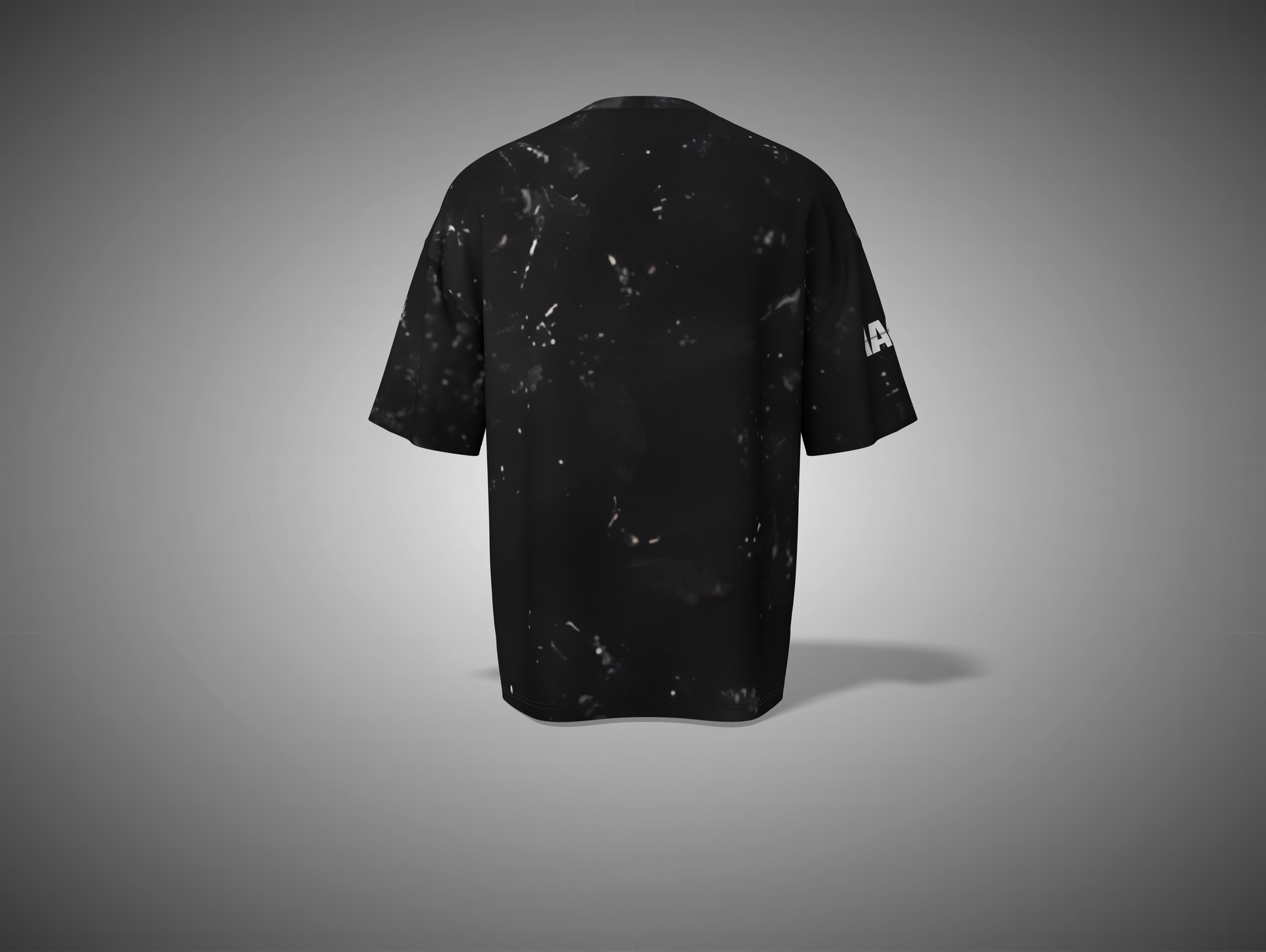 Black t-shirt with white speckles on a gray background