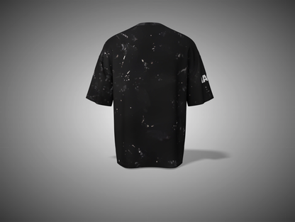 Black t-shirt with white speckles on a gray background