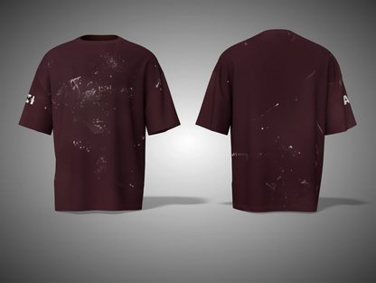 Maroon t-shirt with splatter design on a gray background