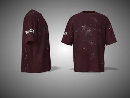 Maroon t-shirt with white splatter design on a gray background