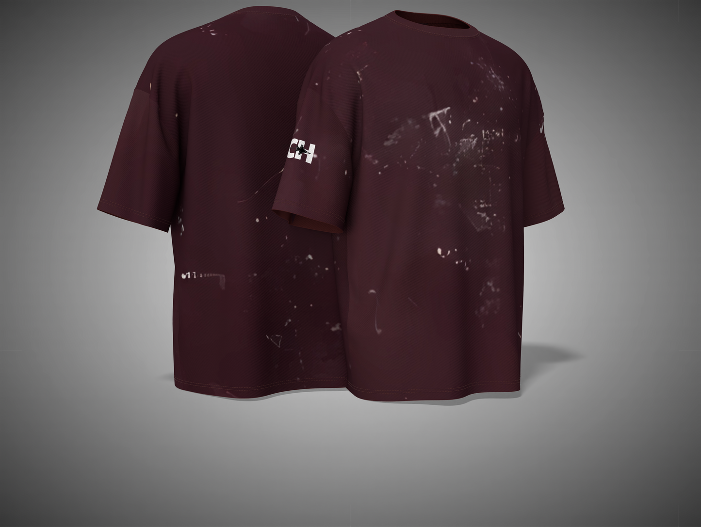 Maroon t-shirt with splatter design on a gray background