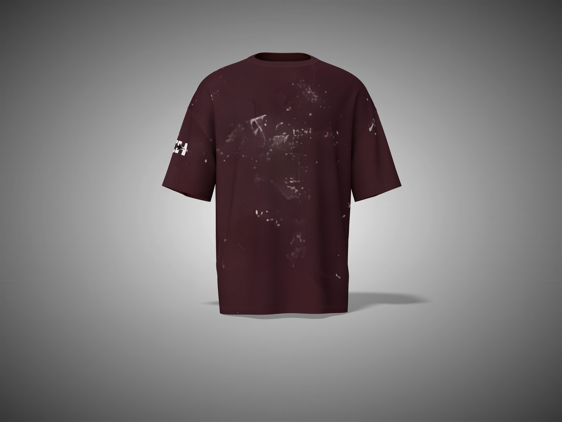 Maroon t-shirt with splatter design on a gray background