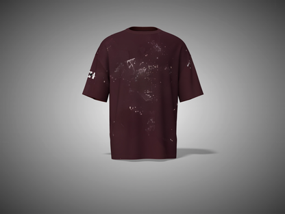 Maroon t-shirt with splatter design on a gray background