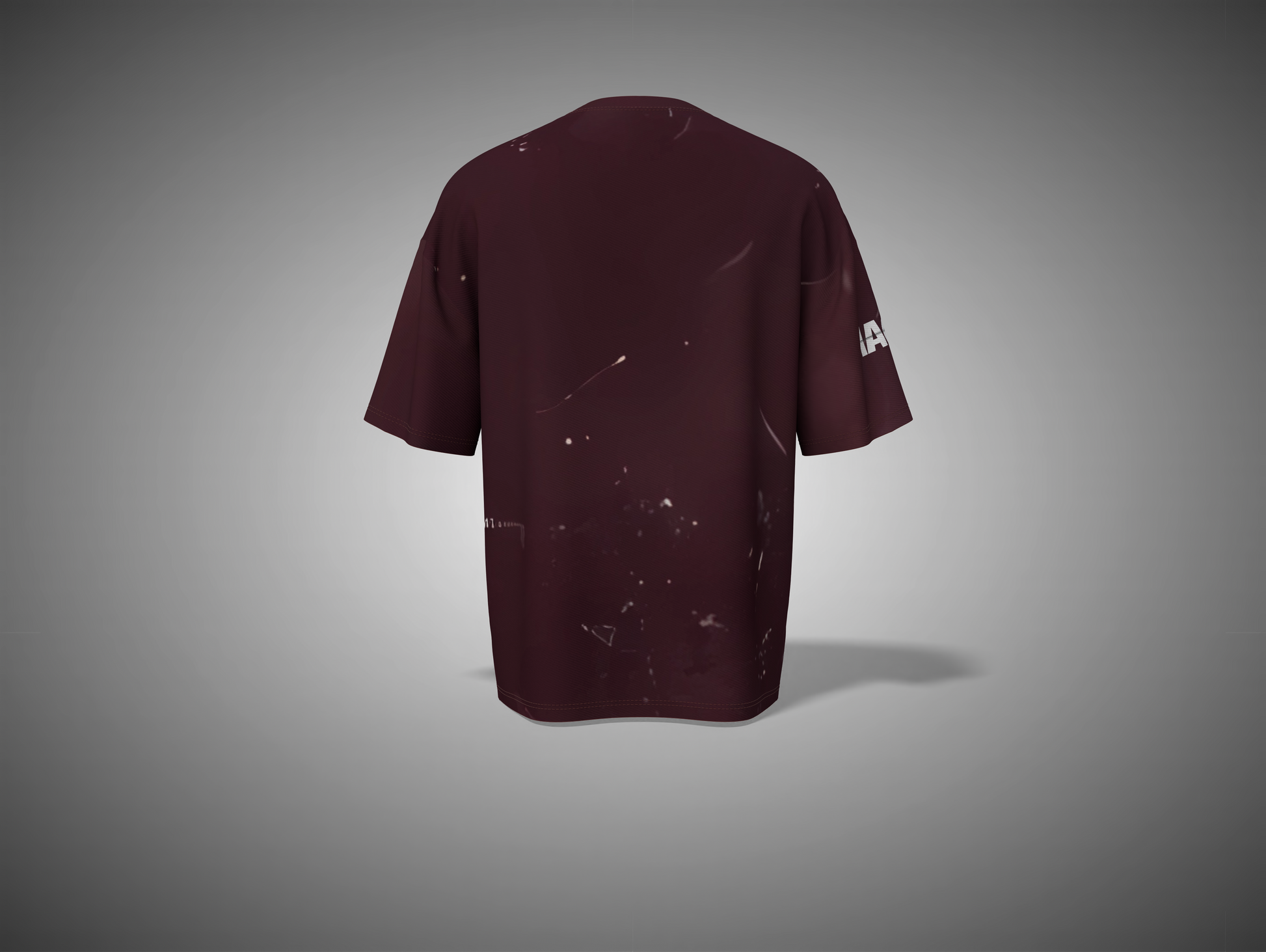 Maroon t-shirt with a small logo on the sleeve against a gray background